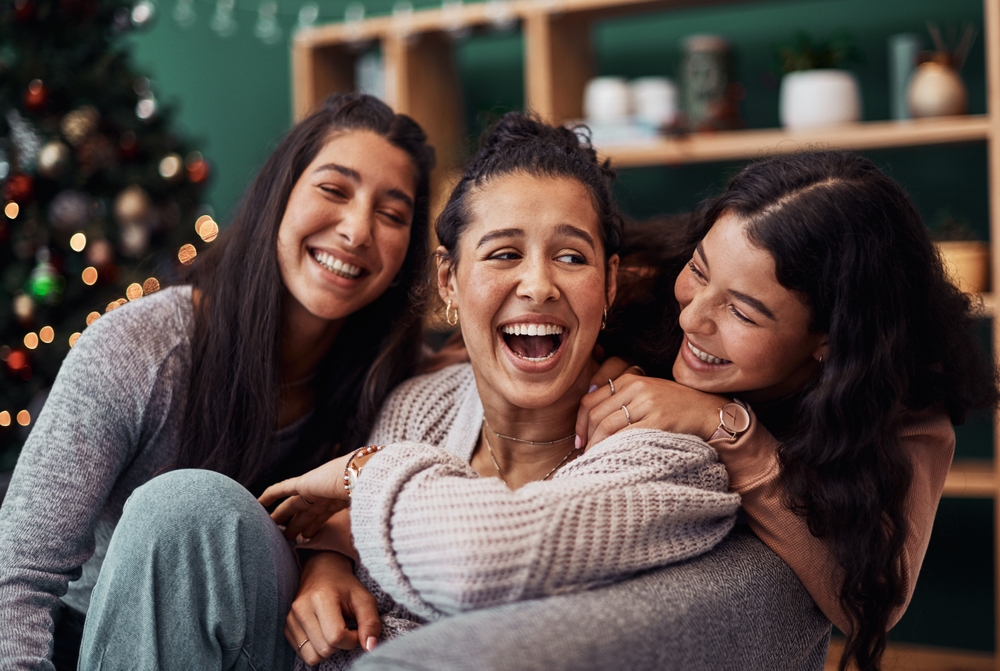 Family,,Women,And,Laughing,In,Lounge,For,Christmas,,Holiday,And - Alicia Dorn Counseling - Alicia Dorn Counseling Family members enjoying time with their chronically ill loved one during the holiday season.